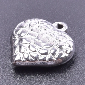 Macro shot of silver heart pendant featuring a unique hammered texture for jewelry making
