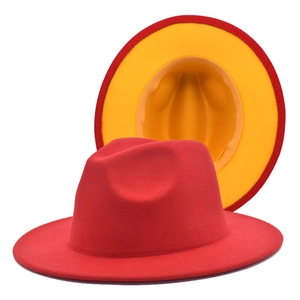 Detail view of red fedora hat featuring a vibrant yellow interior and brim lining