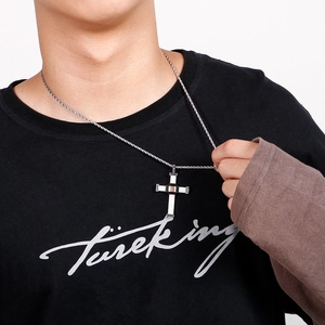 Men's titanium steel cross pendant necklace with silver rope chain shown on model