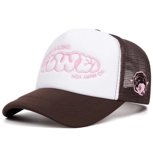 Detail of pink 3D puffy embroidery and mesh texture on retro brown trucker hat