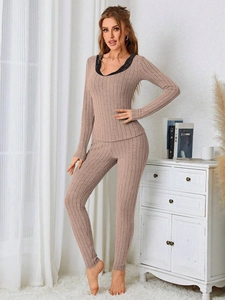 Detail of pink loungewear set with elegant black lace trim and ribbed fabric texture