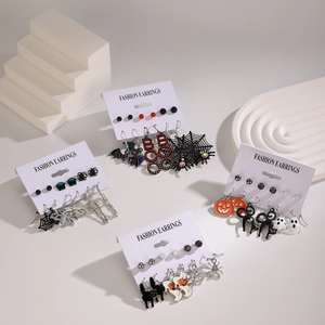 Detail of Halloween earring set featuring pumpkin, ghost, and spider web charms