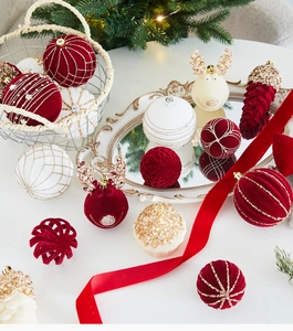 Detail view of festive champagne gold and red velvet ornaments with glitter finish