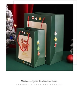 Detail of green Christmas gift bags with transparent windows and festive cartoon patterns