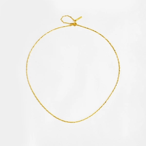 Detailed view of S925 sterling silver golden wave chain necklace on white background