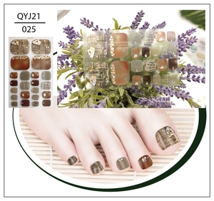 Detail of plaid toe nail wraps with gold foil and rhinestones for summer nail art