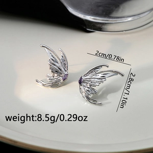 Macro view of butterfly wing earring with purple marquise zircon and silver metallic texture