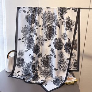 Elegant silk-like floral scarf with black and white botanical print and satin finish