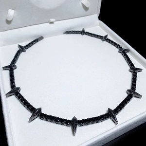 Detail of 5mm black tennis chain with sharp black spike pendants in white jewelry box