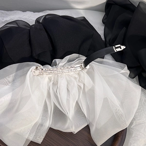Macro shot of white multi-layer chiffon bow hair clip with spring metal clasp details