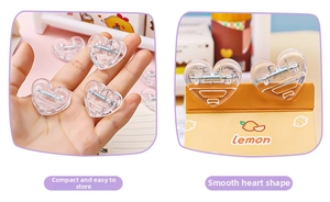 Detail showing small heart-shaped transparent plastic clip for paper and snacks