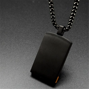 Close-up of a matte black rectangular tiger eye stone pendant with a black bead chain