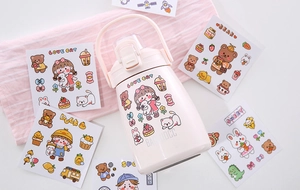 Detail of pink vacuum flask showing portable ring handle and cute cartoon stickers