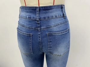 Detailed back view of high waist vintage elastic flared jeans showing pockets and washed denim
