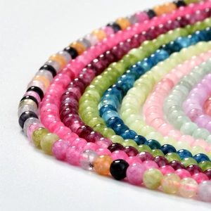 Detailed macro view of multi-colored pink quartz and tourmaline polished round beads