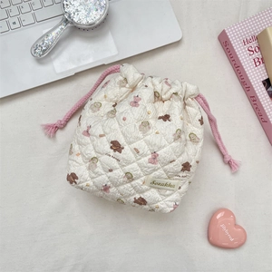 Detailed view of quilted cotton drawstring pouch with cute cartoon animal patterns