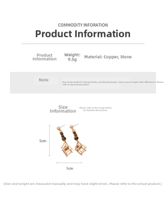 Detailed view of long chair drop earrings featuring copper frames and stones