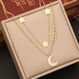 Close-up of double-layer gold star and moon necklace with inlaid mother of pearl pendant