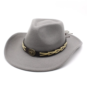 Detail view of charcoal gray felt cowboy hat featuring bronze bull head metal emblem buckle