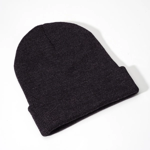Detailed view of the fine ribbed knit texture on a classic black winter cuffed beanie