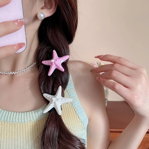 Detailed view of starfish hair clips with textured finish on a model hairstyle