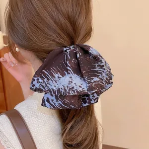 Retro semicircular fabric shark clip with brown abstract patterns for low ponytail