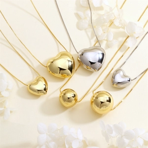 Polished heart and sphere pendants on thin necklaces in gold and silver finish