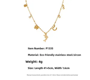 Detail view of gold stainless steel necklace with dolphin and heart zircon pendants