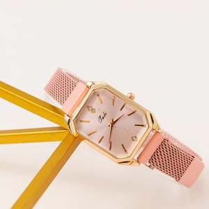 Women's rose gold rectangular quartz watch with pink Milanese mesh strap on gold stand