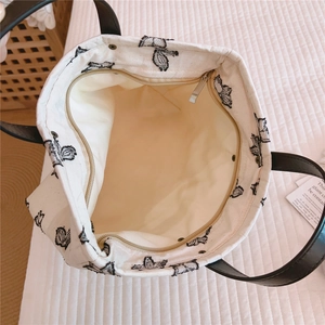 Vue intérieure du sac cabas en toile avec doublure crème et fermeture éclair dorée