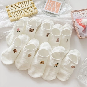 Detail of white cotton low-cut socks with varied cute animal embroidery patterns