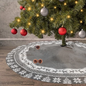Detail of grey knitted Christmas tree skirt with white reindeer and snowflake motifs