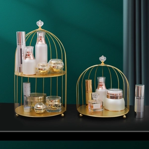 Golden birdcage perfume stand with luxury metal tiers for skincare and cosmetics