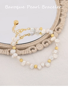 Detailed close-up of Baroque pearl bracelet with golden beads on vintage mirror
