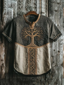 Detailed close-up of Tree of Life embroidery on vintage charcoal and khaki t-shirt