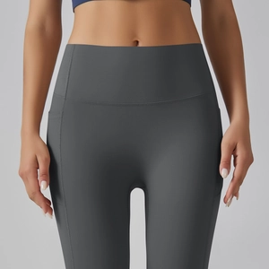 Detail of high-waisted gray yoga pants showing practical side pockets and seamless stitching