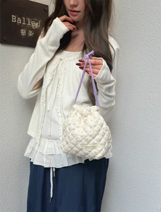 Close-up of the elegant quilted floral fabric on a drawstring travel storage pouch.