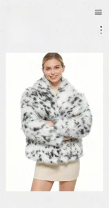 Detail shot of the plush faux fur texture on the black and white spotted leopard coat
