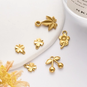 Golden stainless steel plant pendants featuring sunflower and clover on a ceramic plate