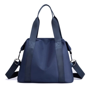 Navy blue nylon shoulder bag with long adjustable straps in a front-facing studio view