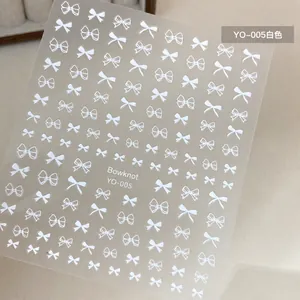 Detail of white bowknot nail art stickers featuring solid and hollow designs, model YO-005