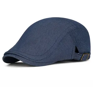 Detail view of denim flat cap showing metal adjustable buckle and breathable side eyelets