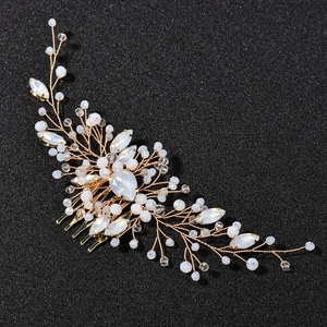 Detail of bridal hair comb with emerald green crystals and gold wire floral design