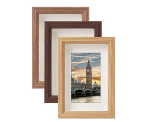 Three-color wooden photo frames with white matting displayed in a stacked arrangement