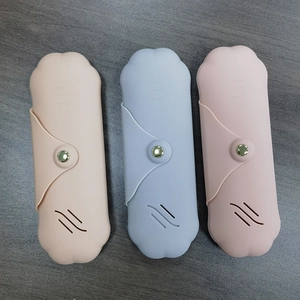 Detailed view of silicone makeup brush cases in beige, blue, and pink with snap buttons