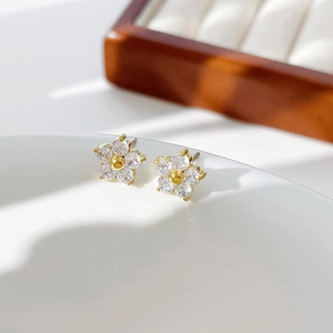 Delicate gold-plated flower stud earrings with sparkling crystals for daily wear