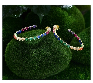 Macro shot of 14k gold-plated hoop earrings with colorful teardrop-cut zircon gemstones