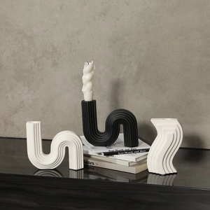 Minimalist S-shaped ceramic candle holder with matte vertical stripes in black and white