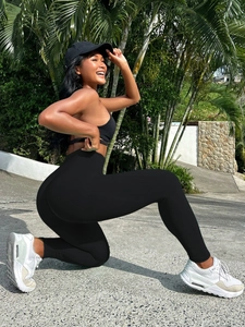 Close-up of black high-waisted seamless yoga leggings and moisture-wicking sports bra set