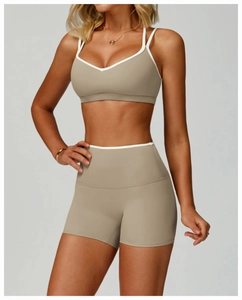 Detail view of khaki sports bra and high-waisted shorts with white contrast binding